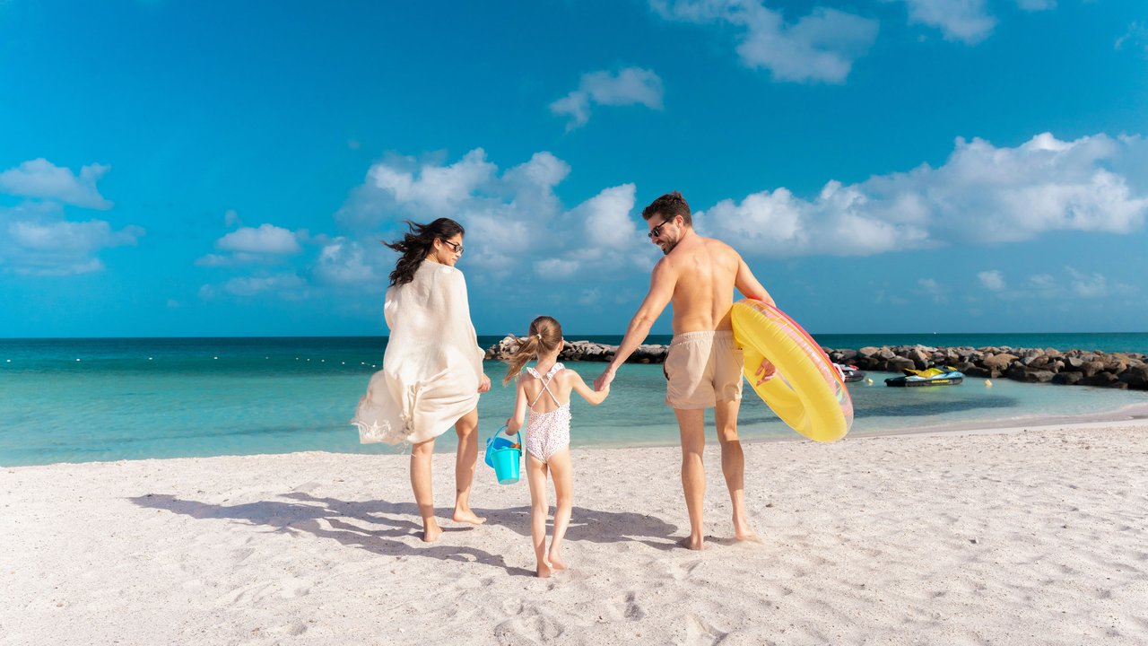 Family beach scene at Embassy Suites by Hilton Aruba Resort