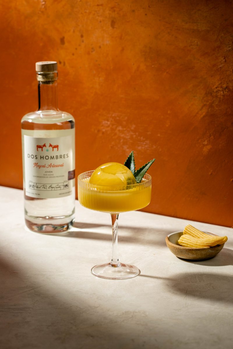 La Otra Palabra mezcal cocktail in coupe glass with corn and agave garnish