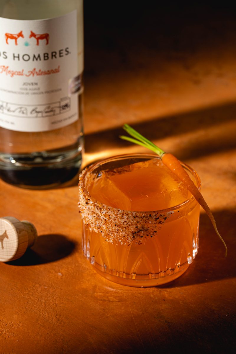 Sweet Lips mezcal cocktail with chili salt rim and carrot garnish