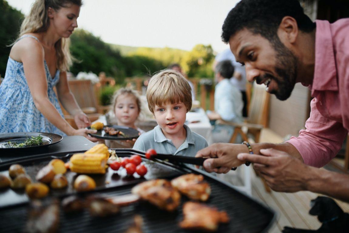kids and dad are grilling safely